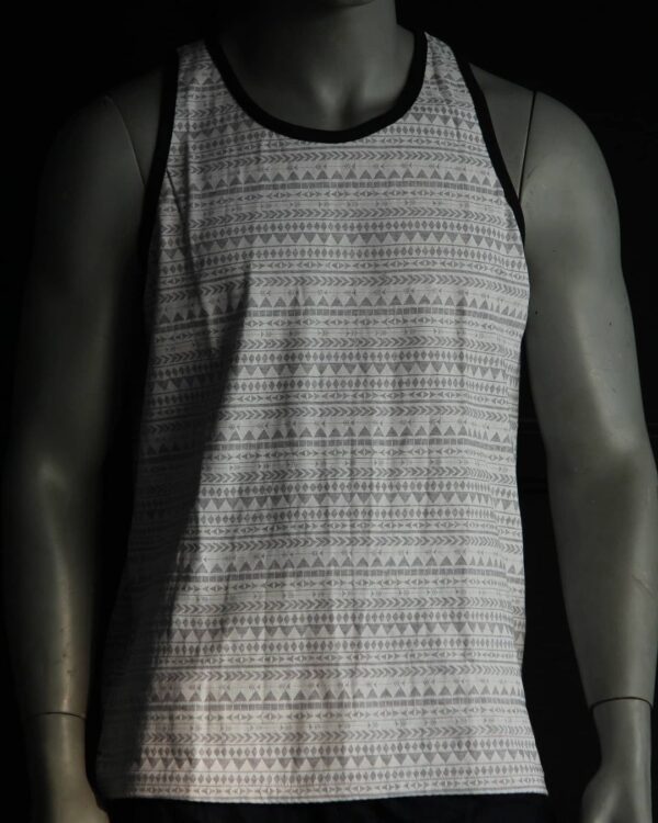 White sleeveless t shirt with Aztec print and black piping on the sleeve.