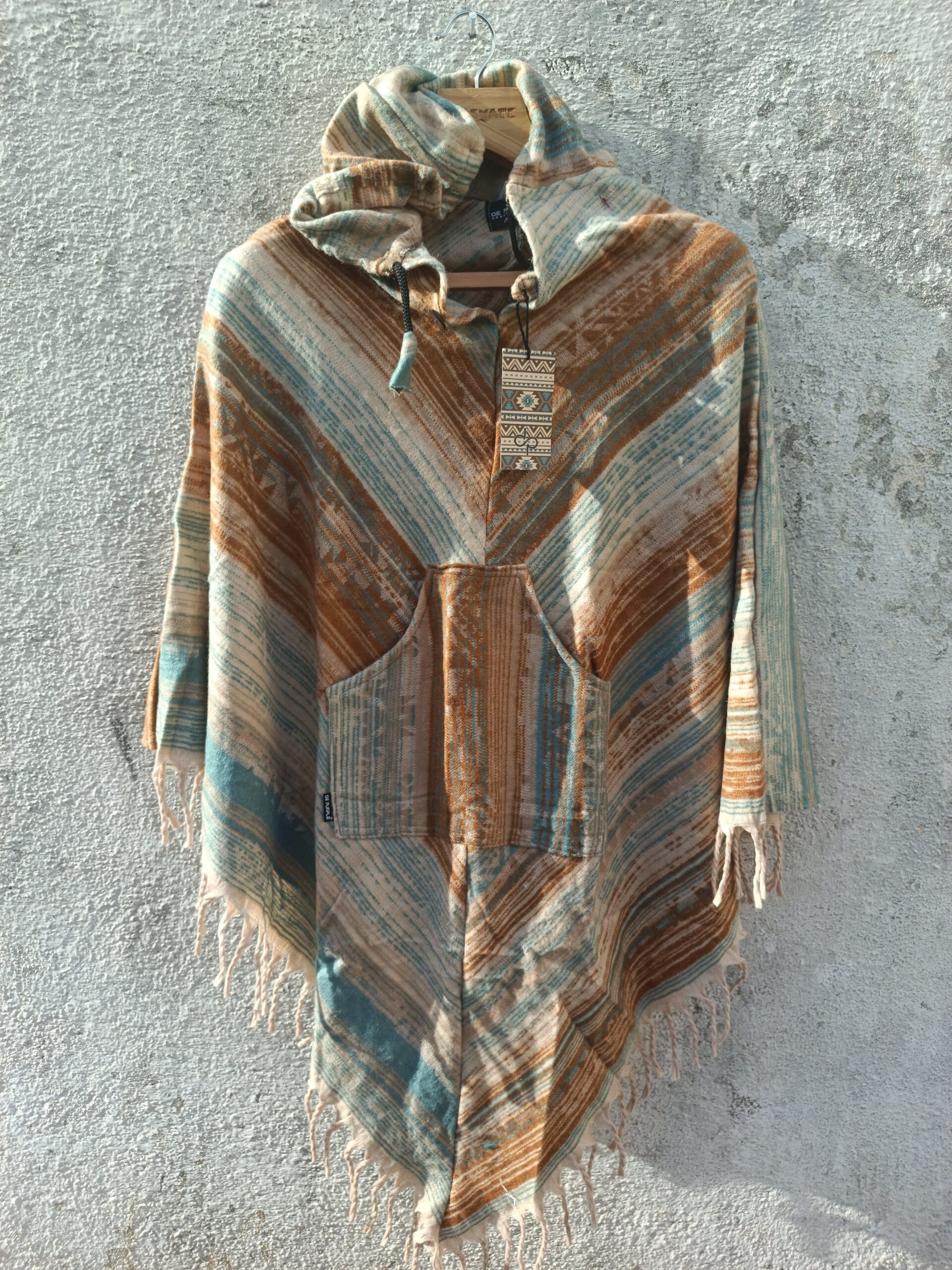 Multicolored printed Poncho with a drawstrring hoody,front pocket with a comfortable design our poncho is made from pure, soft, and breathable wool.